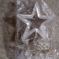 Window curtain string lights with star-shaped decorations