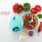 Hand-held vegetable chopper with stainless steel blades, detailed view.