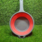 Collapsible colander folded flat on kitchen counter